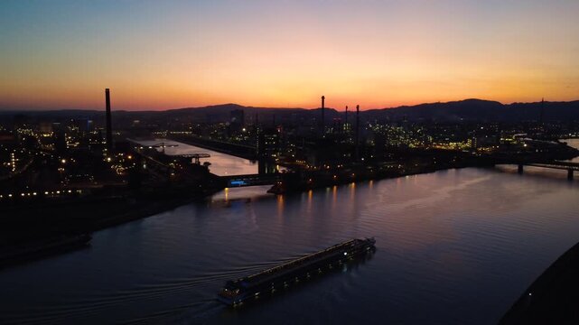 Aerial view of Linz industrial skyline along the Danube at dusk