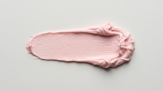 Close-up of smooth pink cosmetic cream swatch on neutral background for beauty product testing Soft pink cream texture sample ideal for skincare or makeup advertising visuals