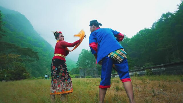 Male Indonesian Dancer in Dramatic Low Stance in a Misty Mountain Field