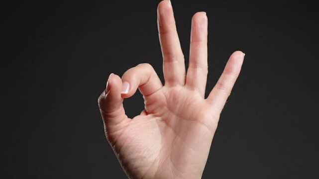 Close-up of Hand Making Perfect OK Approval Sign Gesture