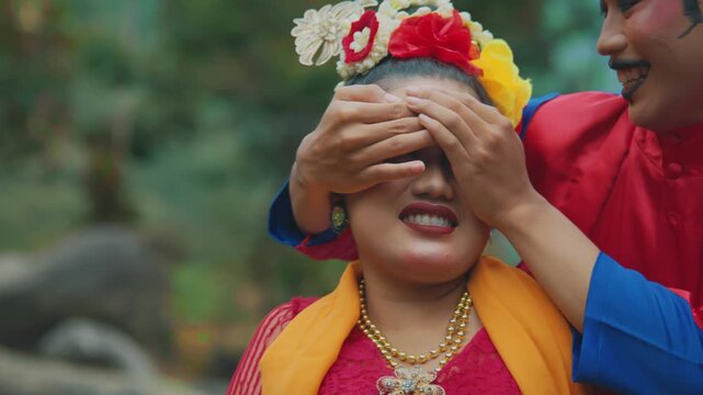 Playful Romantic Moment of Indonesian Traditional Dancers