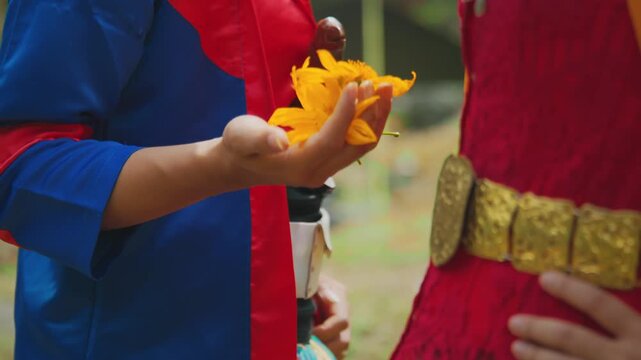 Detail of Traditional Dancer Hand Holding Yellow Flower