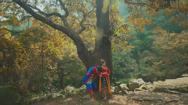 Romantic Pose of Traditional Couple Under Forest Tree