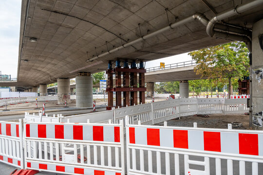 Sicherung der maroden Br&uuml;cke Budapester Stra&szlig;e in Dresden wegen akuter Einsturzgefahr mit schweren Metallst&uuml;tzen und Bauzaun im Sommer 2026. Eine provisorische Unterkonstruktion st&uuml;tzt den Beton ab.