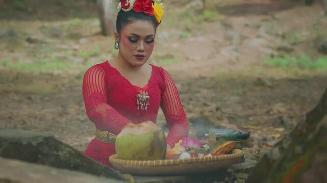 Woman Conjuring Energy over Offerings in Haunted Forest