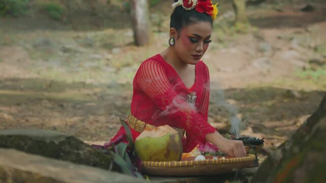 Javanese Dancer Purifying Self with Incense Smoke in Forest