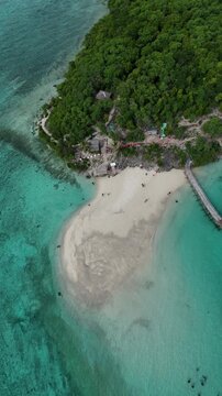 Sand spit and jetty on a forested island near Oslob Cebu aerial