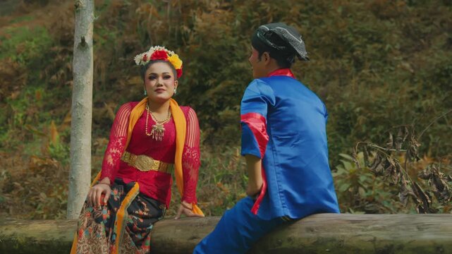 Traditional Dancer Couple Relaxing Together in Forest Setting