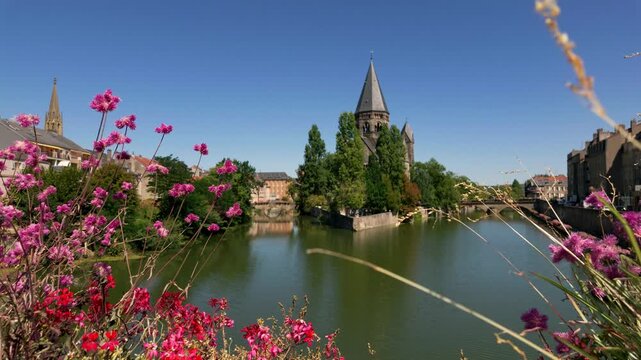 Picturesque view of the Temple Neuf protestant church on an island in the Moselle river in Metz