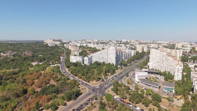Aerial drone approach toward the Gates of Chisinau residential buildings on Dacia Boulevard, showing urban traffic, apartment blocks and the Botanica district of Chisinau, Moldova.