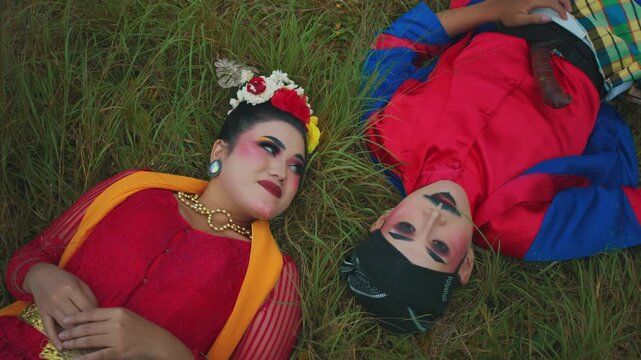Romantic Eye Contact Between Couple Lying on Meadow