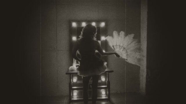 Black and white film color old style silhouette retro lady looking into mirror hand holding waving fan white ostrich feathers. sexy woman burlesque show dancer actress back view. Flapper girl 20s roar