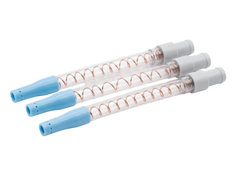 Dental saliva ejector suction tubes with copper wire inside, medical disposable suction tip tools isolated on black background for clinic hygiene procedures and patient oral healthcare equipment.