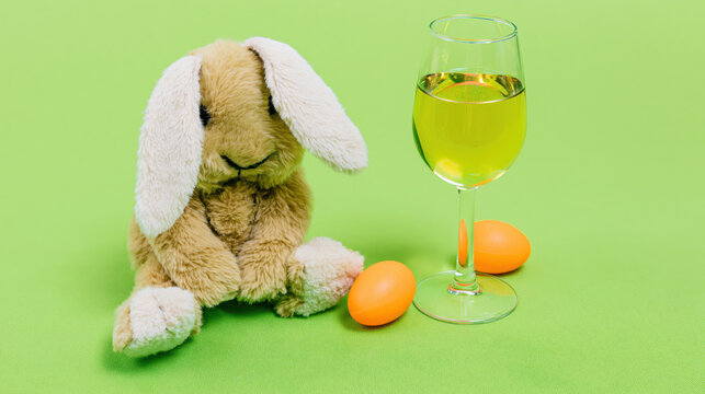 cheerful white easter bunny holding red wine glass beside green egg on mint background flat vector design for holiday advertising web banners greeting cards wellness branding
