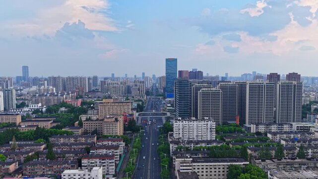 Aerial panoramic city view of mixed‑use urban area with main road running through downtown