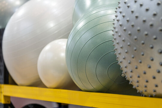 multiple different styles of yoga fitness balls displayed on the shelf