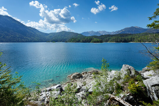 Travel landscape of Zugspitze Alps in Bavaria, Germany, scenic summer nature panorama with forest, Eibsee lake, mountains peak. Alpine landscape
