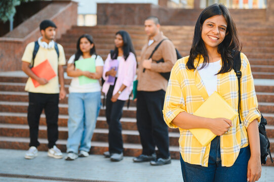 Happy indian female student smiling on campus