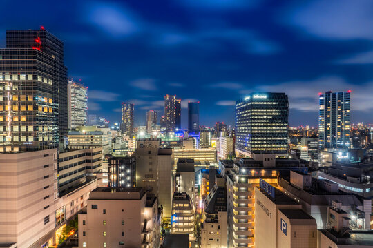 Modern illuminated city skyline and skyscrapers at night in Toshima, Ikebukuro, Tokyo, Japan