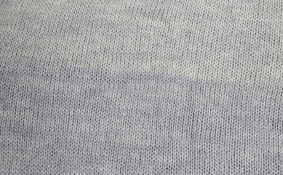 Soft heathered knit fabric with subtle blue gradient for cozy apparel and home decor backgrounds