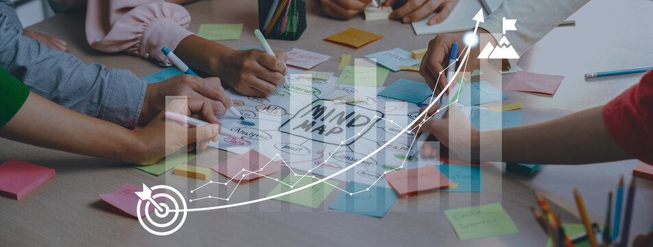 A dynamic brainstorming scene showcasing multiple hands engaged in creating a mind map. Colorful sticky notes and charts enhance the focus on collaborative project planning and innovation. Ledger