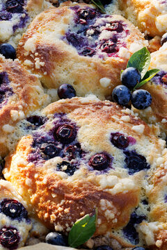 Homemade blueberry buns with addition mascarpone cheese and butter crumble topping, close-up view