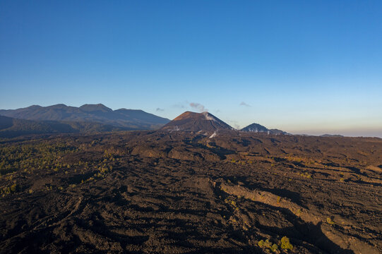 Aerial view of Paricutin volcano with its vast lava fields and volcanic cone under a clear blue sky in San Juan Parangaricutiro, Michoacan, Mexico.
