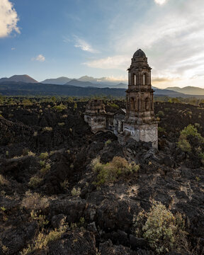 Aerial view of the historic church tower of San Juan Parangaricutiro rising from the solidified lava field of the Paricutin volcano in San Juan Parangaricutiro, Michoacan, Mexico.