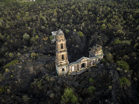 Aerial view of the San Juan Parangaricutiro church ruins, partially buried by black volcanic rock from the Paricutin volcano, in San Juan Parangaricutiro, Michoacan, Mexico.
