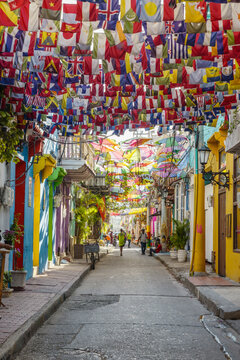 International flags over a colorful Getsemani street, Cartagena, Colombia
