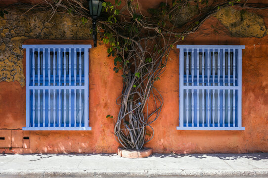 Orange colonial facade with blue windows, Cartagena, Colombia