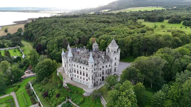 Panoramic drone footage over Dunrobin Castle, historic seat of the Earl of Sutherland featuring 19th-century French Renaissance chateau architecture and Moray Firth sea view in Scotland