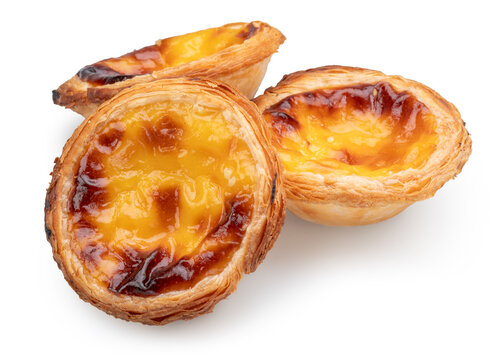 Three traditional Portuguese custard tarts Pastel de Nata isolated on a white background.