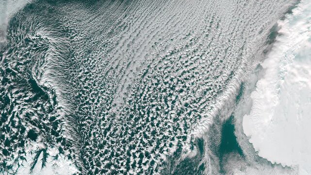 Top shot on cold north water body with cloud formation. Camera is moving left. Animation based on image by NASA