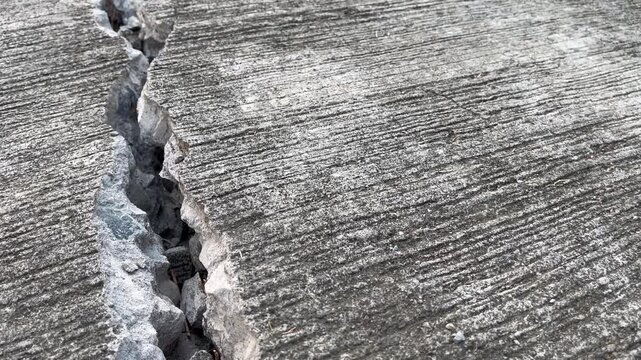 Severe crack on damaged concrete road surface texture