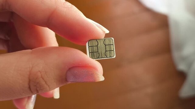 SIM card in hand, mobile internet, cellular connection, international roaming and telecommunications concept.