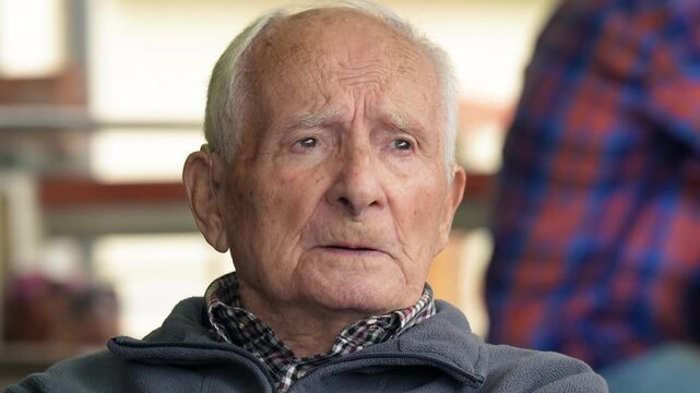 Elderly man portrait showing natural wrinkles and authentic communication expression
