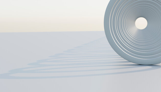 Close-up of a steel coil compression spring casting a spiral shadow