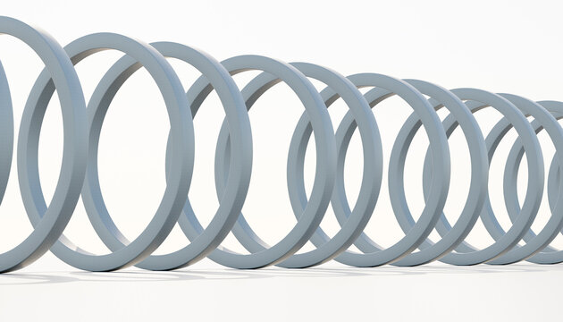 Close-up of a coiled metal spring isolated on a white background