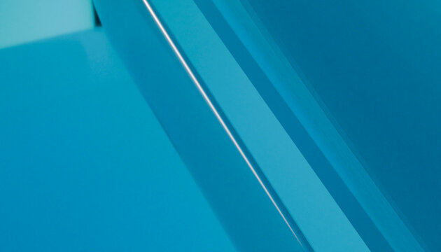 Close-up of layered blue glass showing abstract geometric reflections