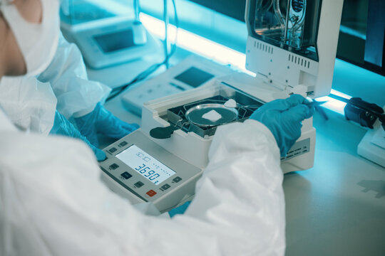 Close up of Scientist Using Moisture Analyzer for Quality Control Testing in Pharmaceutical or Food Industry Laboratory