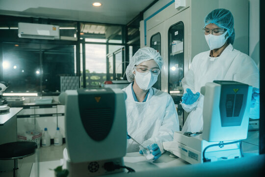Scientists Using Moisture Analyzers in Food or Pharmaceutical Industry Laboratory for Quality Control Research