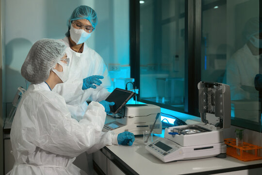 Scientists Using Moisture Analyzer in Food or Pharmaceutical Industry Laboratory for Quality Control Research
