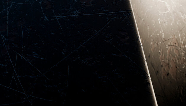 Close-up of scratched and worn dark metal surface under dim lighting