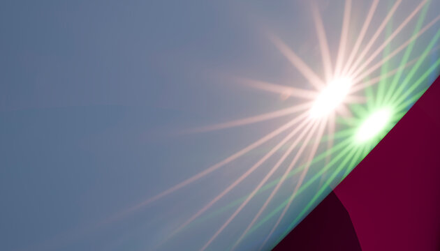 Bright sun flare with lens flare and light beams in a clear sky