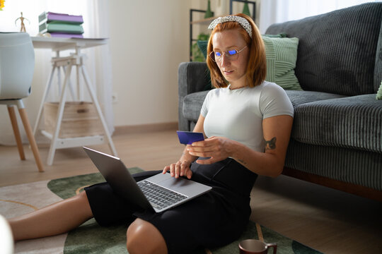 A white woman shopping online with a credit card