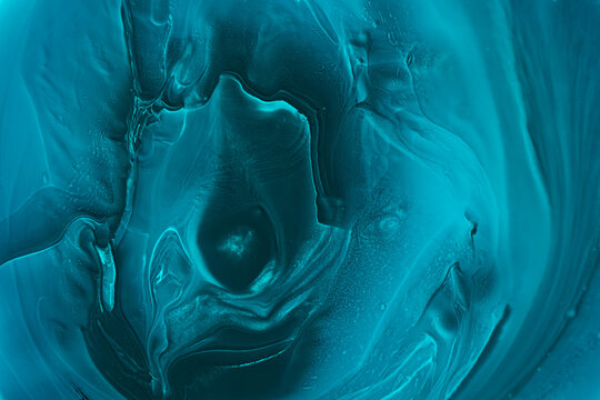an abstract teal fluid art pattern featuring organic, swirling shapes, created using fluid acrylic techniques, alcohol ink manipulation