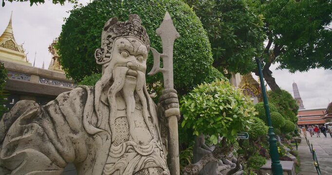 Giant guardians of Wat Phra Kaew are twelve massive statues of mythical demon warriors known as Yaksha sightseeing travel in Bangkok Thailand