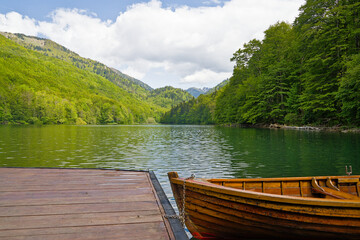 Serene wooden boat docked at tranquil Biogradska Lake © Darkdriver