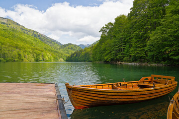 Serene wooden boat docked at tranquil Biogradska Lake © Darkdriver